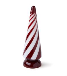 a red and white striped glass cone on a stand