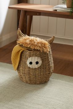 a stuffed animal in a basket on the floor