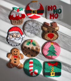 knitted christmas ornaments are displayed on a window sill