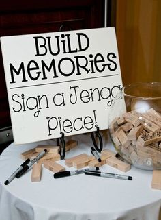 a sign that says build memories on top of a table with scissors and other items