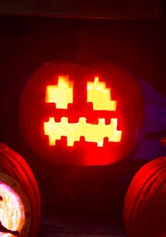 two pumpkins with faces carved into them