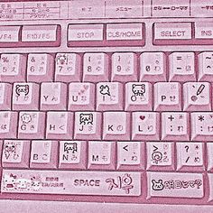 a pink keyboard with hello kitty stickers on it