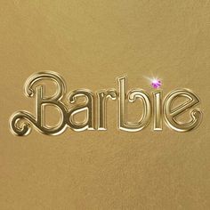 the word barbie written in cursive metal type on a gold background with a pink diamond