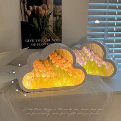 two cloud shaped lights sitting on top of a table