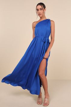 a woman wearing a blue dress with one side slit down and the other side split open