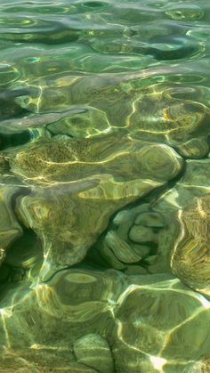 the water is crystal clear and has many small rocks in it's bottom half