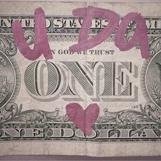 an old one dollar bill with pink writing on it