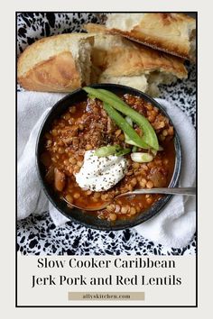 a bowl filled with beans and bread on top of a table