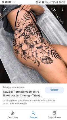 a woman's thigh with flowers on it and the words tatoue tigrea aouado entre flores por