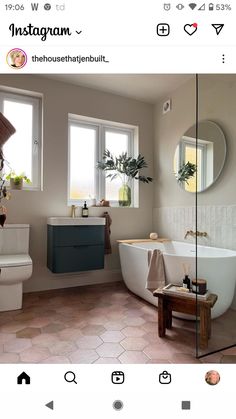 a bathroom with a tub, sink and toilet in it's own photo on instagram