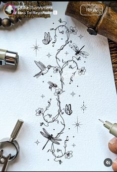 someone is drawing on paper with scissors and some other things around them, including ink