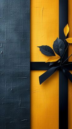 a black and yellow striped gift box with a rose on it's ribbon tied around the bow