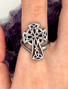 a person wearing a ring with a cross on it