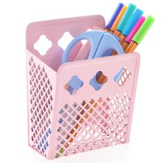 a pink pen holder filled with markers, scissors and other office supplies on a white background