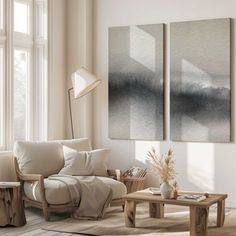 a living room with two paintings on the wall