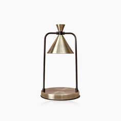 a brass and black table lamp with a metal base on an isolated white background,