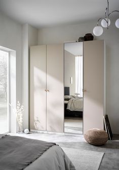 a bedroom with a bed, mirror and closets in it's center area