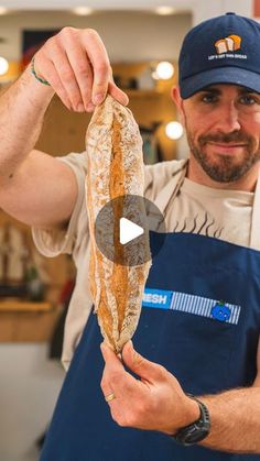 a man holding a loaf of bread in his hands