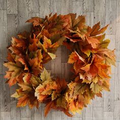 a wreath made out of leaves on a wooden floor