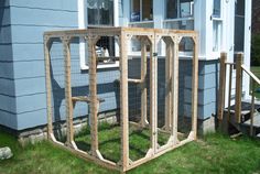 a wooden structure sitting in front of a blue house