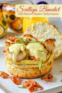 scallops benedict with brown butter hollandaise is on a white platter