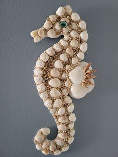 a seahorse made out of shells on a wall