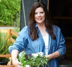 a woman holding a potted plant in her hands