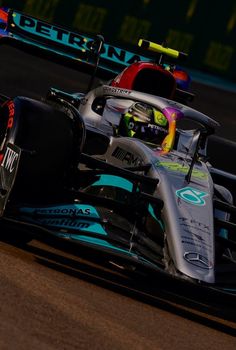 a racing car driving on a track during the day