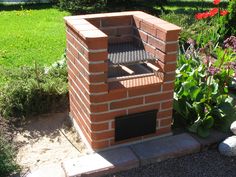 a brick oven sitting in the middle of a garden