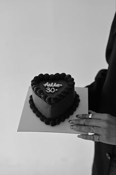 a black and white photo of a heart shaped cake with the number 50 on it