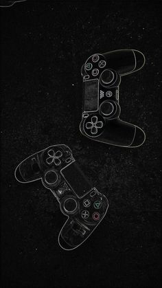 two video game controllers sitting side by side on a black surface, with the top one being drawn