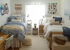 a bedroom with two beds, a desk and pictures on the wall above it in front of a window