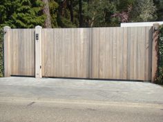 a wooden gate with a brick walkway in front of it