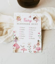 a pink fairy scavenger hunt card next to a jar of honey and a white towel