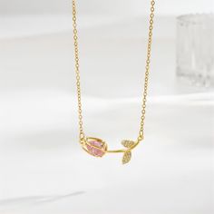 Pink Crystal Gold Tulip Chain Necklace Add a touch of charm to your outfit with our Pink Crystal Gold Tulip Chain Necklace. The delicate chain and sparkling pink crystal tulip pendant make this necklace a must-have accessory for any lover of all things cute and feminine. Tulip Accessories, Tulips Meaning, The Meaning Of Love, Hoco 2024, Tulip Necklace, Feminine Necklace, Classic Flower, Meaning Of Love, Moissanite Jewelry