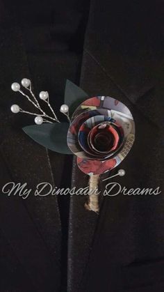 a boutonniere made to look like a flower on a black suit lapel