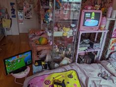 a bedroom with pink and yellow decorations on the walls, bedding, and shelves filled with toys