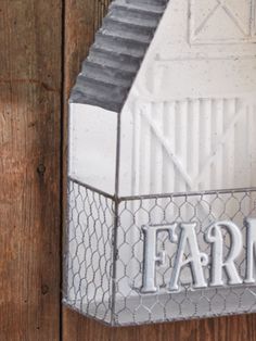 a metal farm sign mounted to the side of a wooden fence