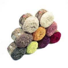 a pile of crochet balls sitting next to each other on a white surface