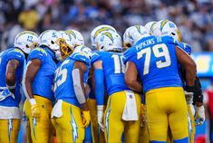 the los angeles chargers huddle together before a game