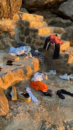 clothes and shoes are sitting on the rocks