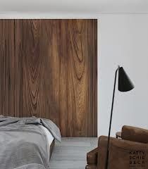 a bed sitting next to a wooden wall in a bedroom