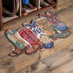 the cowboy rug is on the floor in front of some boots and other items,