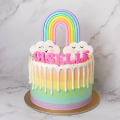 there is a cake with rainbow icing and two bears on top that says pastel