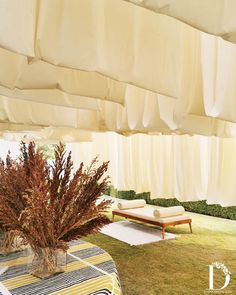 the inside of a tent with tables and chairs