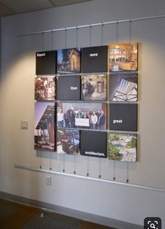 a wall with several pictures hanging on it's side in an office building or conference room