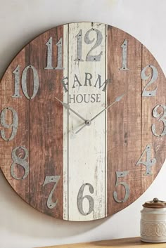 a wooden clock with the words farm house painted on it's face and numbers