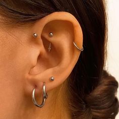 a close up of a person wearing an ear with two piercings on their ears