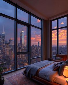 a bedroom with large windows and a view of the city at sunset or dawn in new york