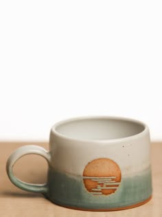 a coffee cup sitting on top of a wooden table